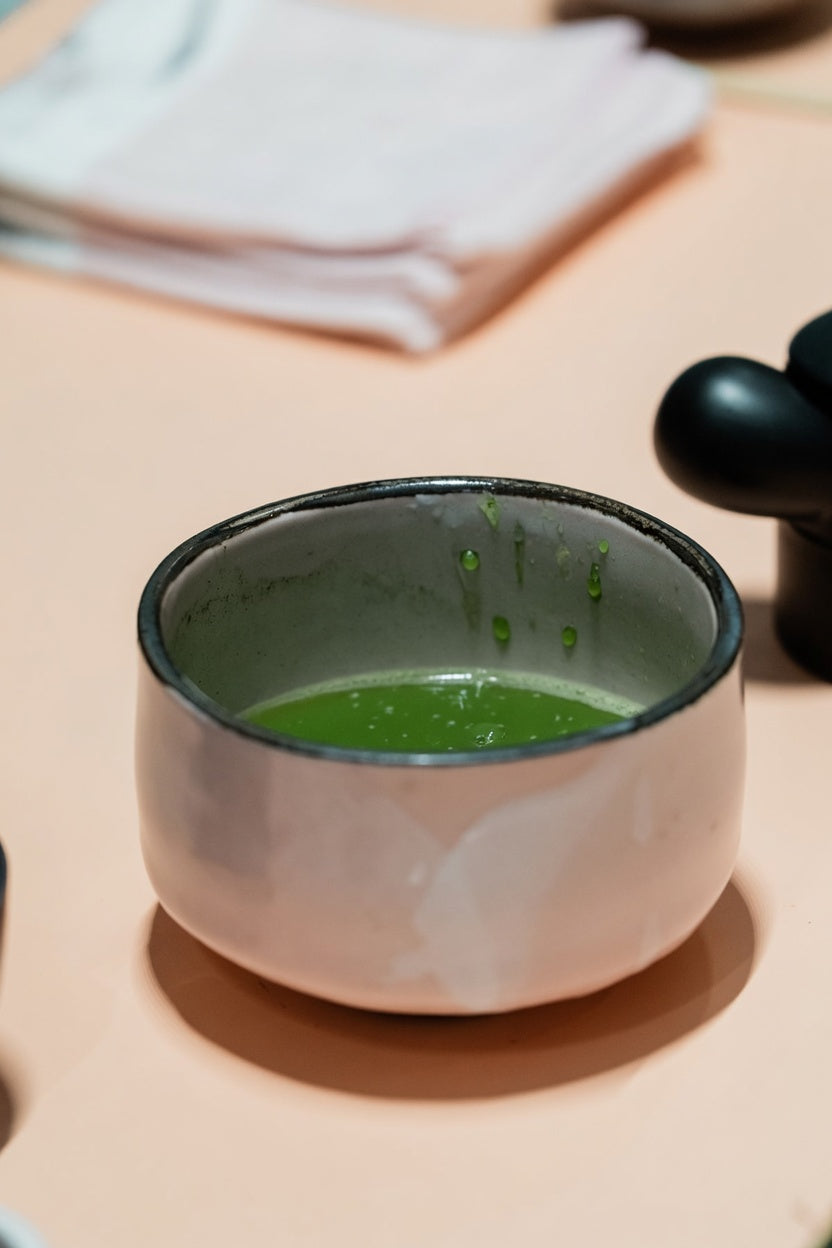 A ceramic bowl of matcha after a sip.